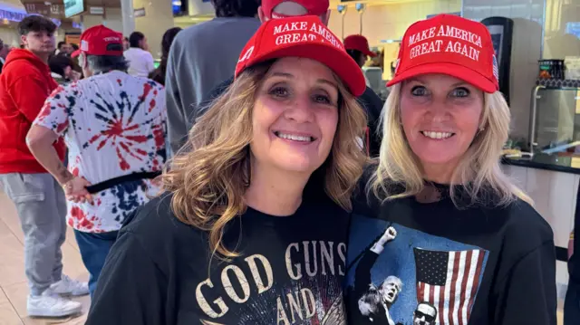 Sharon and Kelly wear MAGA hats and Trump t-shirts