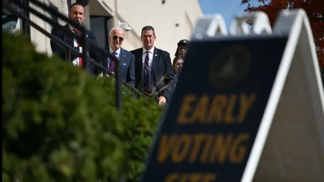 Joe Biden waits in line to vote