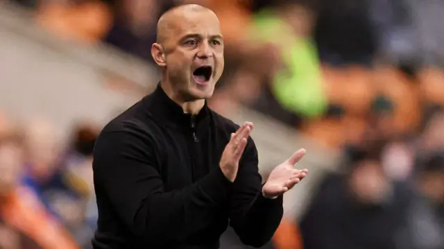 Wigan manager Shaun Maloney claps his side in encouragement.