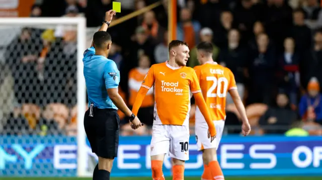 Blackpool's Sonny Carey receives a yellow card.