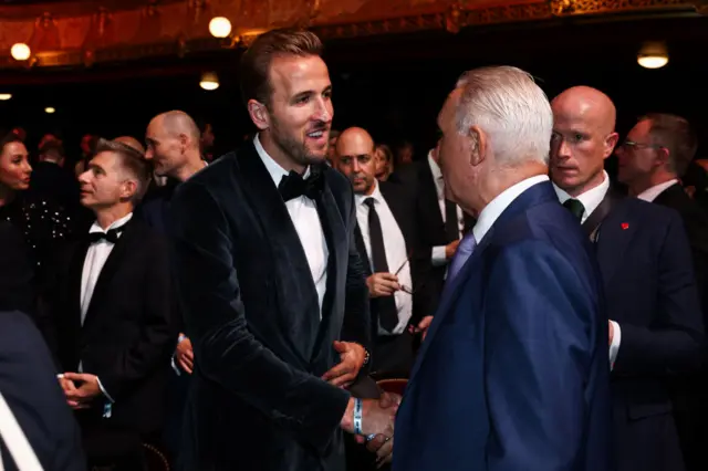 Bayern's English forward Harry Kane shakes hands with former Bulgarian player Hristo Stoichkov