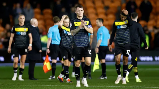 Wigan players at full-time following their 2-2 draw with Blackpool.