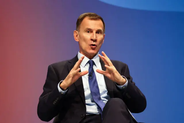 Former Conservative chancellor Jeremy Hunt in a black suit making a speech