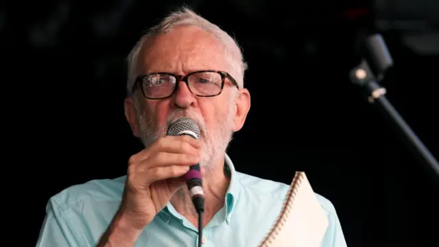 Corbyn speaks into a microphone