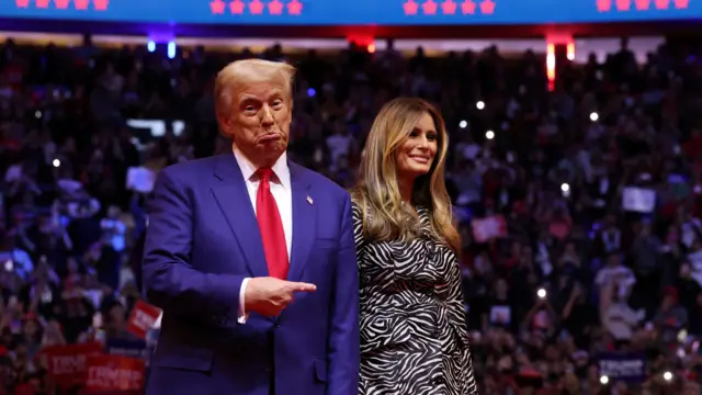 Republican presidential nominee and former U.S. President Donald Trump points his finger next to Melania Trump during a campaign rally at Madison Square Garden, in New York, U.S., October 27, 2024.