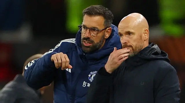 Ruud van Nistelrooy speaks to Erik ten Hag while watching a Manchester United game