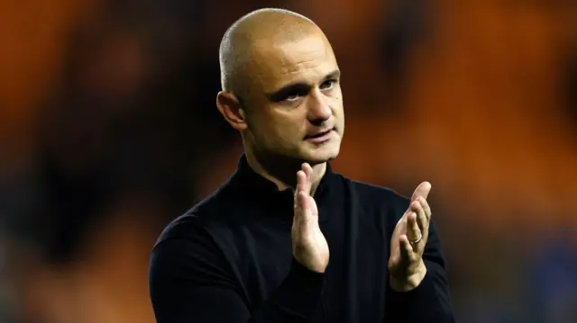 Wigan Athletic manager Shaun Maloney claps the travelling support at Bloomfield Road.