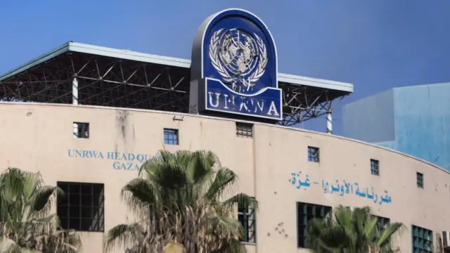 A damaged sign is pictured at the headquarters of UNRWA, following an Israeli raid, amid the Israel-Hamas conflict, in Gaza City