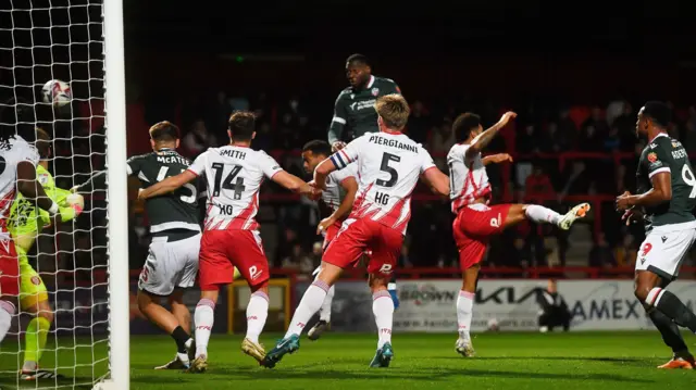 Richard Santos leaps to open the scoring for Bolton