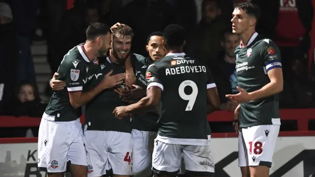 Bolton players celebrate John McAtee's goal at Stevenage