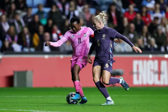 Thembi Kgatlana of South Africa runs with the ball whilst under pressure from Alex Greenwood