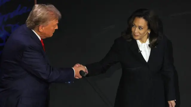 Donald Trump and Kamala Harris shaking hands