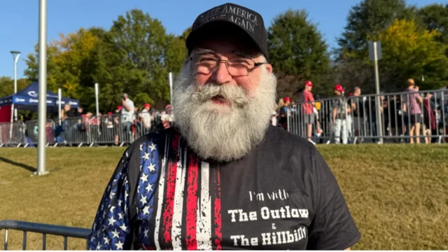 Volunteer Dean Cottle wearing a Make America Great Again hat stood outside