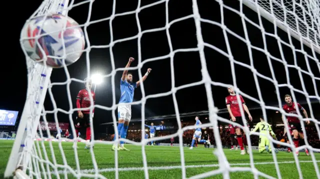 The ball nestles into the corner of the Reading net