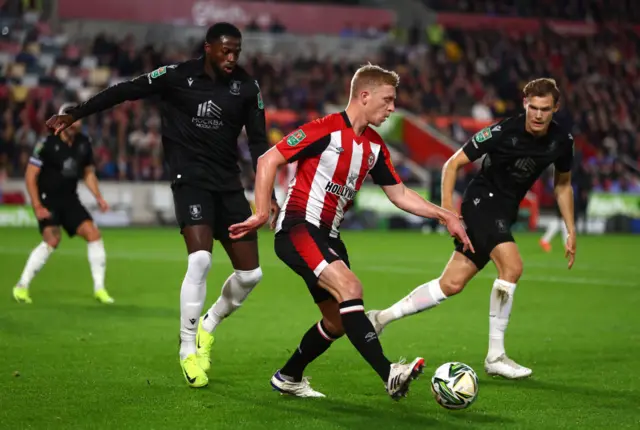 Ben Mee of Brentford and Svante and Dominic Iorfa of Sheffield Wednesday in action during the Carabao Cup Fourth Round match