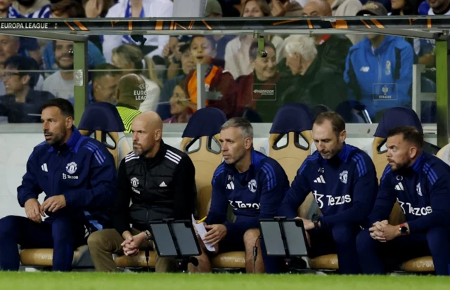 Manchester United assistant manager Ruud van Nistelrooy and manager Erik ten Hag watch the match from the bench