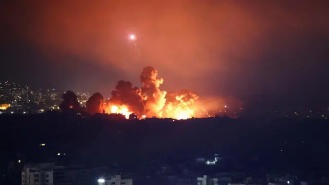 Smoke and flames rise over Beirut's southern suburbs after a strike,