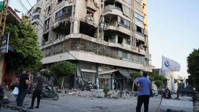 A man looks at a damaged building at the site of an Israeli strike on central Beirut's Bachoura neighbourhood