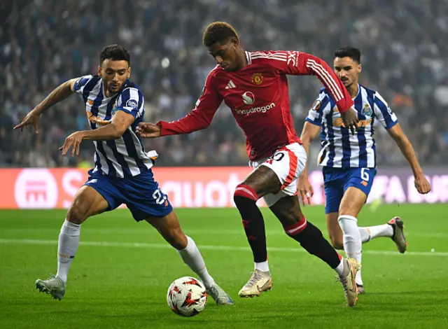 Marcus Rashford of Manchester United runs with the ball whilst under pressure from Joao Mario