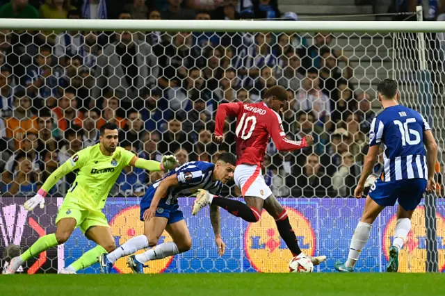 Marcus Rashford is challenged by FC Porto's Argentine defender #24 Nehuen Perez