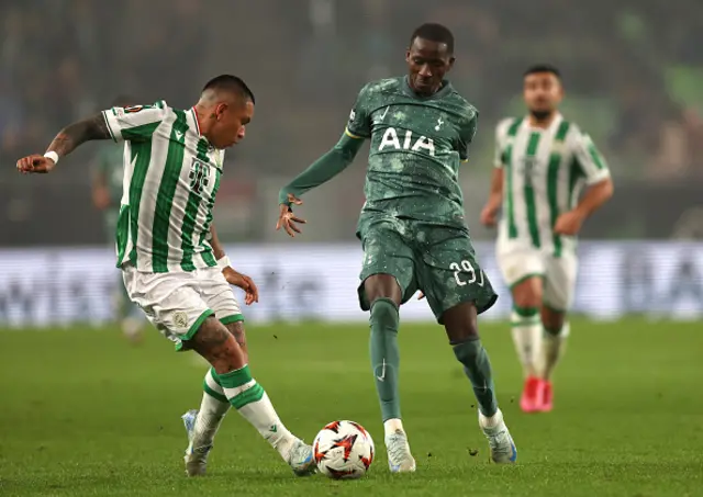 Cristian Ramirez of Ferencvaros passes the ball whilst under pressure from Pape Matar Sarr