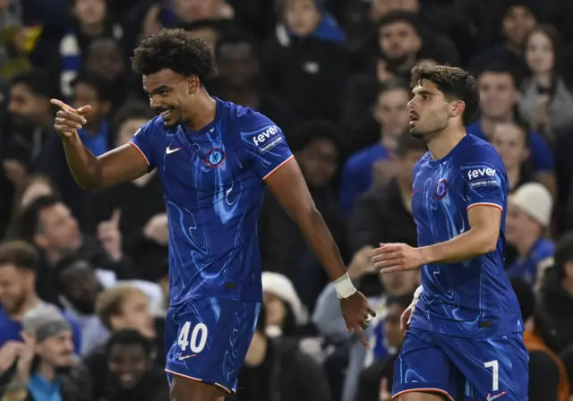 Chelsea's Renato Veiga celebrates scoring their first goal with Chelsea's Pedro Neto pointing at team-mates