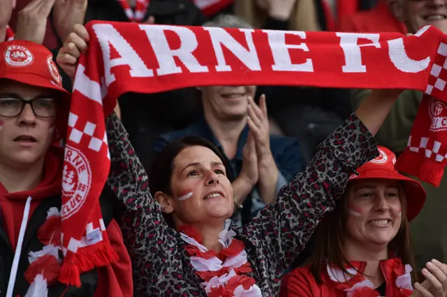 Supporter of Larne FC holds scarf