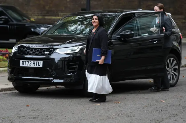 Shabana Mahmood walking from a black car in Downing Street, holding a blue folder