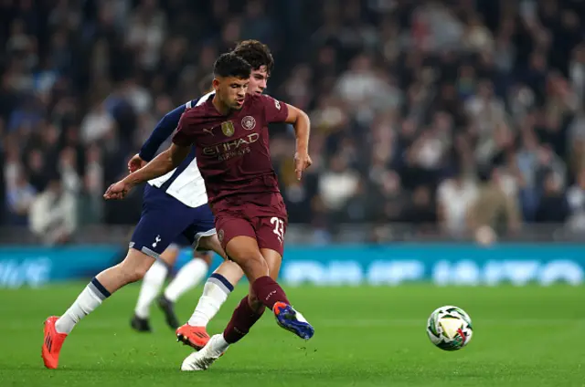 Joao Cancelo of Manchester City and Archie Gray of Tottenham Hotspur in action