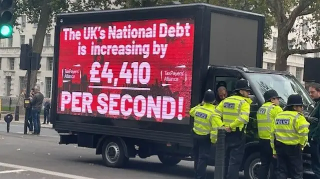 A van from the Taxpayers’ Alliance with a message that says the UK's national debt is rising by £4,410 per second