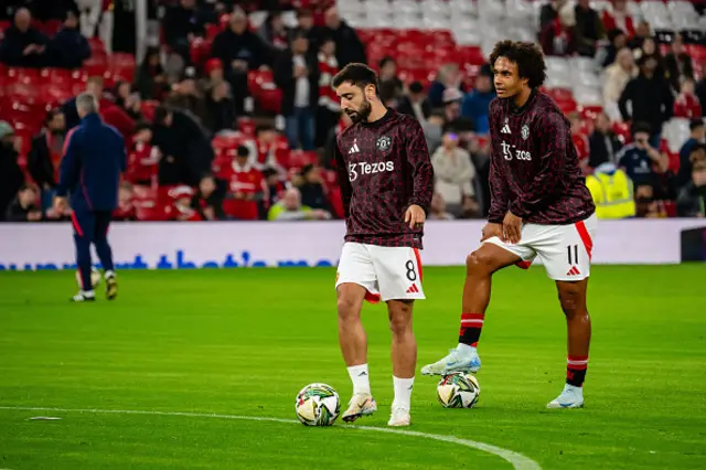 Bruno Fernandes and Joshua Zirkzeeof Manchester United warm up