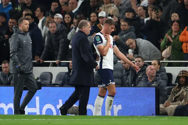 Micky van de Ven of Tottenham Hotspur is consoled by Ange Postecoglou