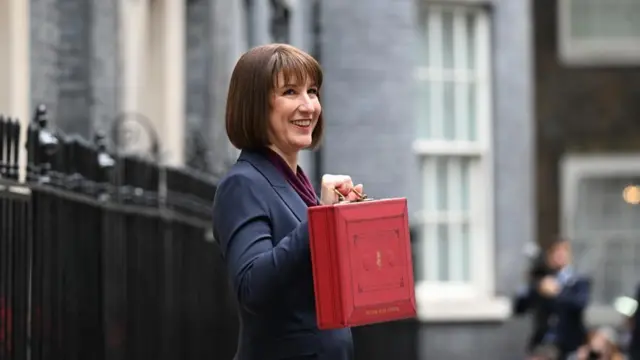 Chancellor Rachel Reeves holds up the red box outside 11 Downing Street .