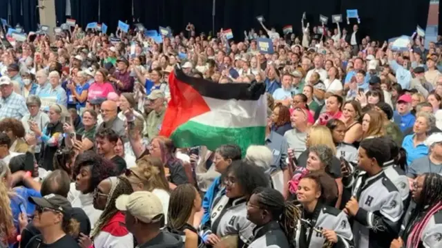 A protester holds up a Palestinian flag