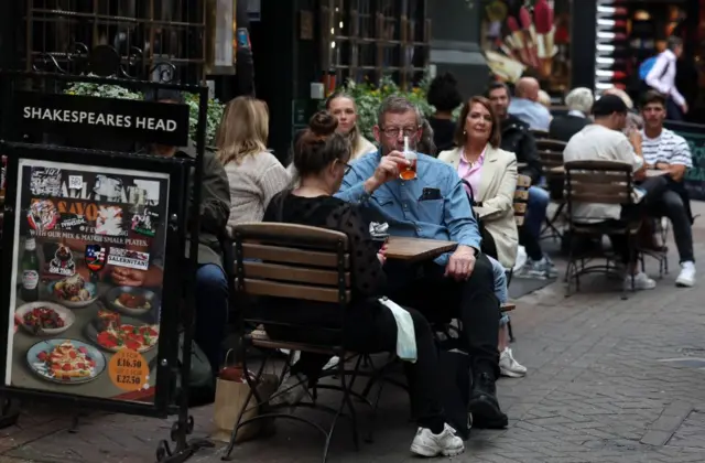 Customers outside a pub in London