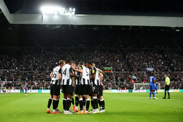 Newcastle players celebrate in a huddle