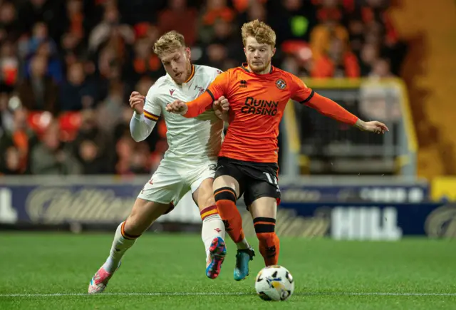 Dundee United's Luca Stephenson (R) and Motherwell's Ewan Wilson in action during a William Hill Premiership match between Dundee United and Motherwell at the CalForth Construction Arena at Tannadice Park