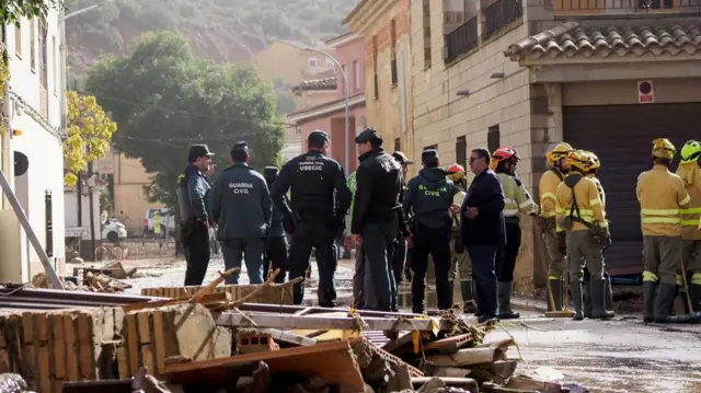 Spanish emergency services members gather in the flood-hit municipality of Mira