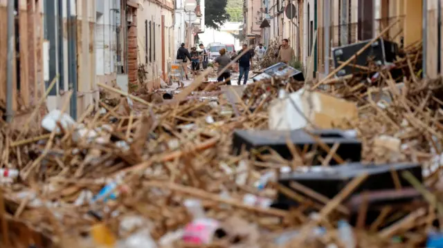 Residents check the damage in the flood-hit municipality of Paiporta, in the province of Valencia