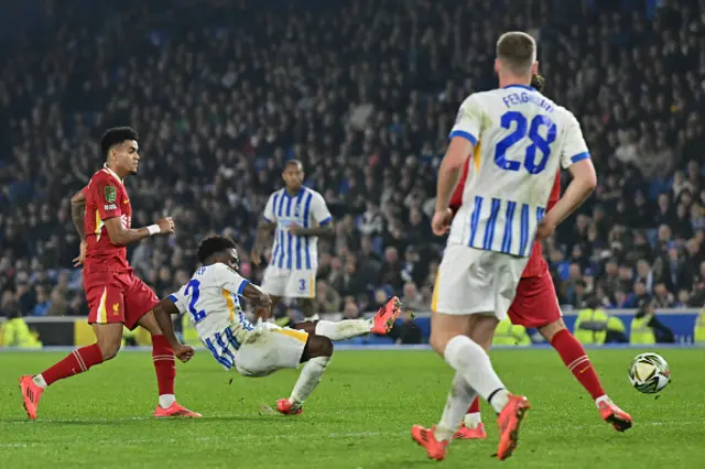 Tariq Lamptey (2L) shoots to score