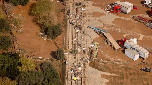 Aerial image showing large amounts of debris over a train track