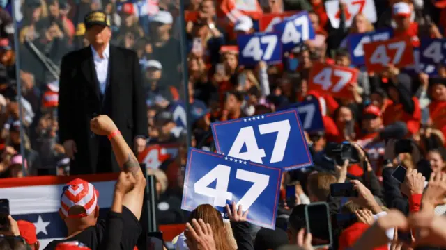 Republican presidential nominee and former U.S. President Donald Trump attends a campaign rally in Albuquerque, New Mexico, U.S. October 31. He is surrounded by supporters holding signs reading "47"