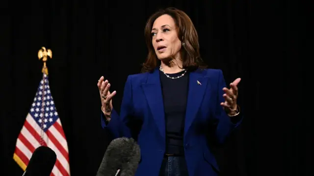 Harris speaks to members of the media before leaving her hotel in Madison, Wisconsin on October 31, 202