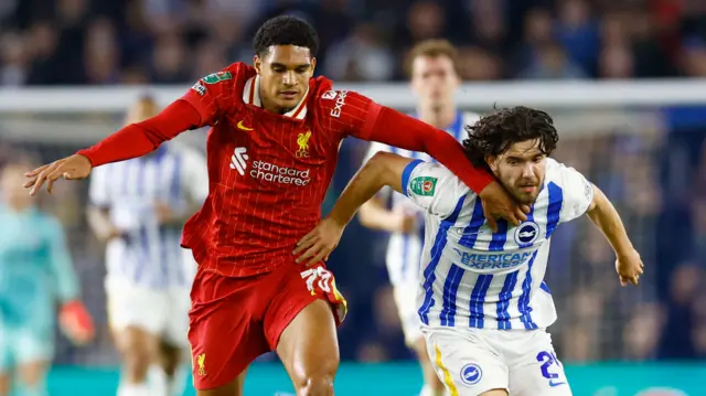 Liverpool's Jarell Quansah holds off Brighton's Ferdi Kadioglu