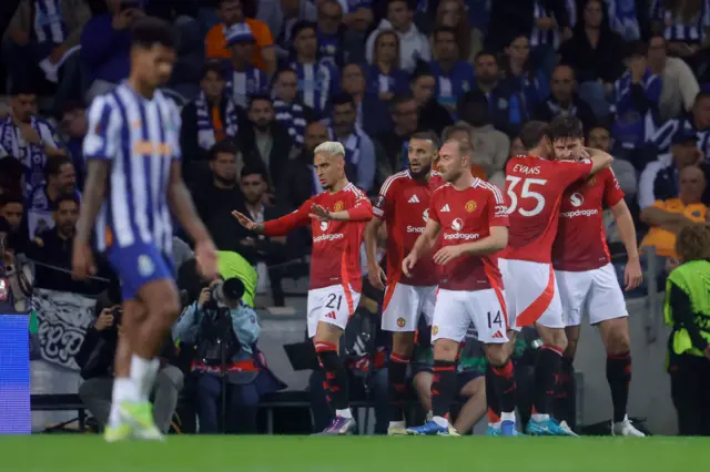 Manchester United players celebrate scoring against Porto