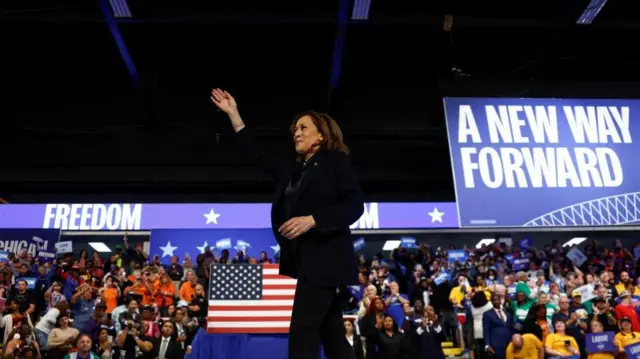 Kamala Harris waves at the crowd at her rally in Flint, Michigan on 4 October, 2024.