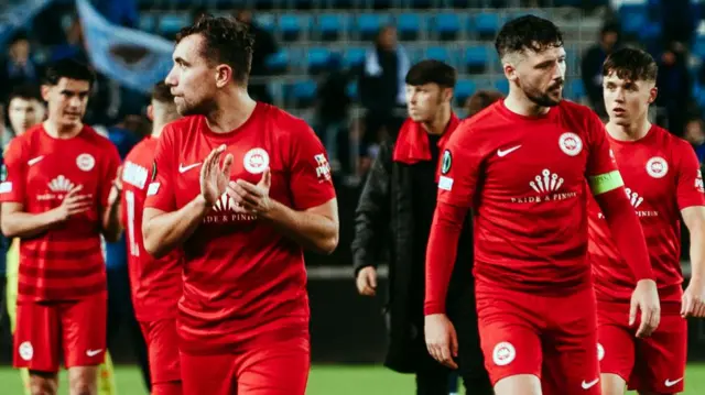 Larne’s players and management acknowledge the fans support after tonights 3 0 defeat away to Molde.