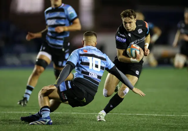 Jamie Dobie hurdles Callum Sheedy on his way to the line for Glasgow's score