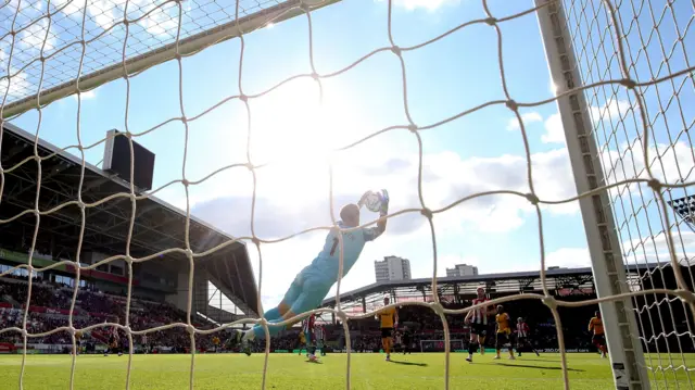 Brentford goalkeeper Mark Flekken makes a save during the Premier League match at the Gtech Community Stadium, London. Picture date: Saturday October 5, 2024.