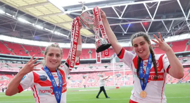 St Helens women's players hold up the Women's Challenge Cup trophy at Wembley